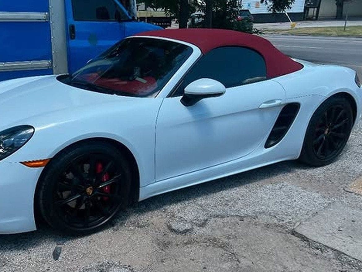 A white sports coupe with fresh film on the side and rear glass