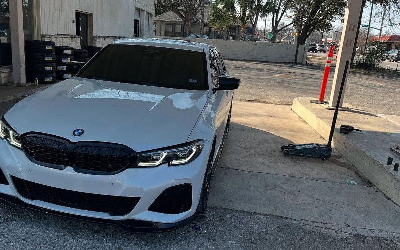 A tinted BMW 3-series parked outside the shop on East University Avenue